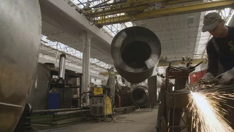 Man is welding in a factory Stockbeeldmateriaal 95982724