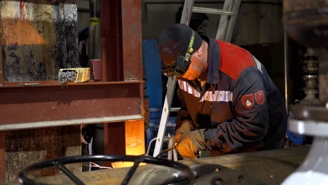 The man is welding at the factory Stock Footage 103182369