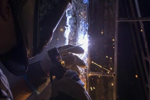 A man welding a gate hinge joint Stockfoto's
