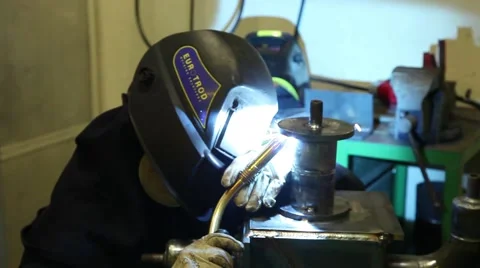 Man with welding helmet welding machine steel Stock Footage 64771985