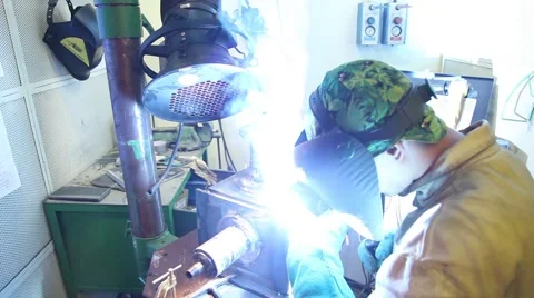 Man with welding helmet welding machine steel Stock Footage 64772123