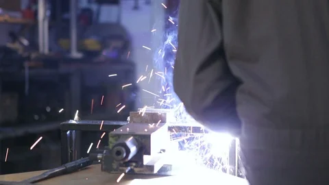 A man welding in his workshop. Close up. High definition video. Stock Footage 88357140
