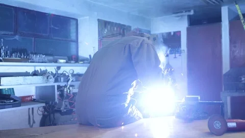 A man welding in his workshop. High definition video. Stock Footage 88355375