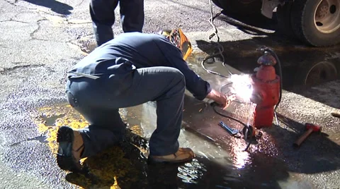 Man welding a hydrant Stock Footage 36099377