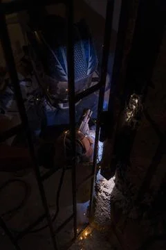 A man welding from the inside of the gate 写真素材