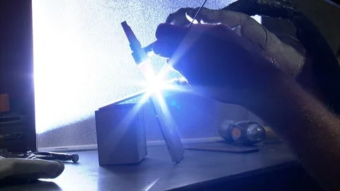 Man welding a metal tablet Stock Footage 99048305