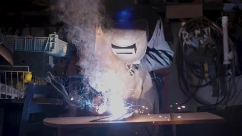 Man welding metal in vintage workshop Stock Footage 174694942