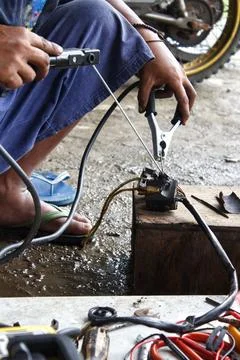 A man is welding a motorcycle switch Foto stock