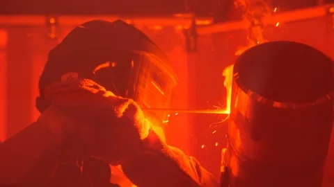 Man welding a pipe behind a red curtain in slow motion Stock Footage 120297958