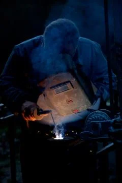 Man welding with reflection of sparks on visor Stock-Fotos