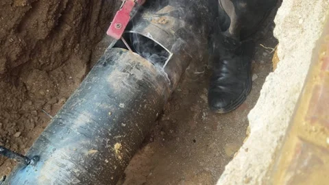 A man is welding a thick iron pipe. Stock Footage 323380637