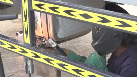 Man welding the underside of the car in desert project slow motion close up Video stock 144801157