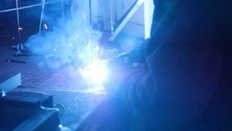 Man welds two pieces of iron with a welding machine Stock Footage 101536663