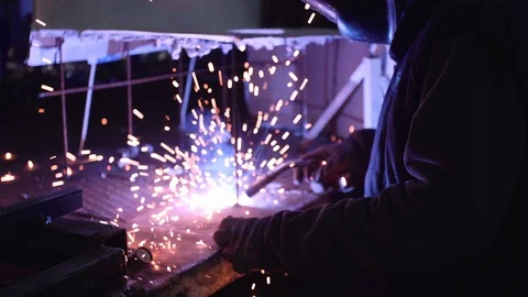 Man welds two pieces of iron with a welding machine Stock Footage 101541212