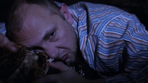 The man went to bed, unable to sleep, worrying night Stock Footage 84741372