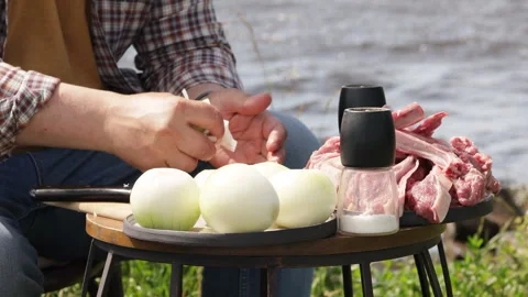 Man went on a picnic stands next to an open trunk of a car with a bunch of stuff 動画素材 278537885