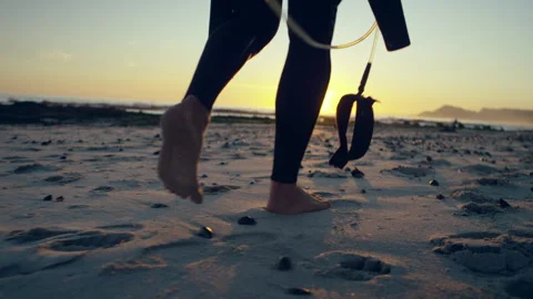 Man with a wetsuit at the beach Stock Footage 279782593