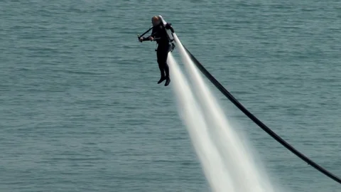 Man in wetsuit with jetpack  performs flight over of Gelendzhiksok Bay. Stock Footage 124578792