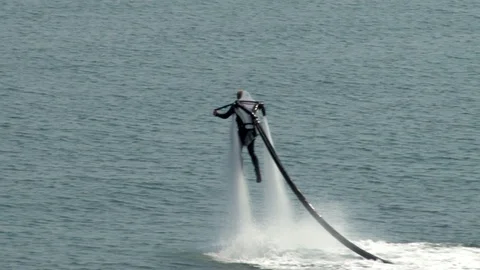 Man in wetsuit with jetpack  performs flight over of Gelendzhiksok Bay. Stock Footage 125304501