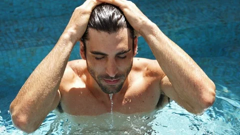 Man wetting hair in pool Stock Footage 89463741