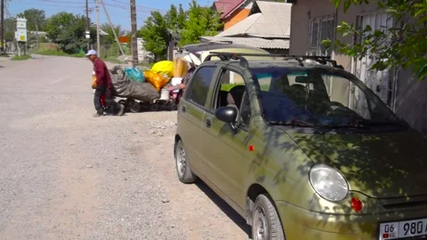 A man with a wheelbarrow with a load on the street. Stock Footage 245943145