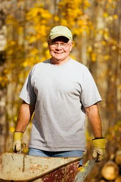 Man With A Wheelbarrow Stock Photos