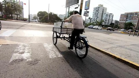 A man on a wheelbarrow sells bread. Фото