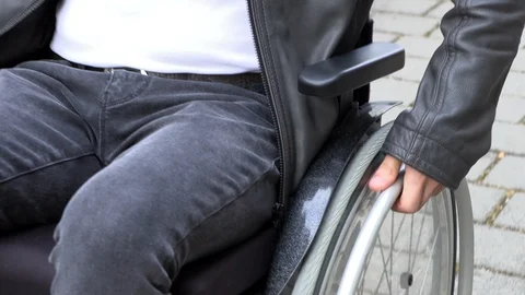 A man in a wheelchair cannot drive into a small shop Stock Footage 125512647
