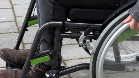 A man in a wheelchair cannot drive into a small shop Stock Footage 125514089