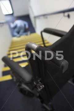 Man in wheelchair falling downstairs Stock Photos
