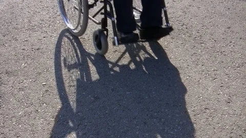 Man in a wheelchair on plain background 库存影片 93292976