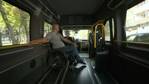Man in wheelchair in the special the vehicle. The disabled person Stock Footage 142277632