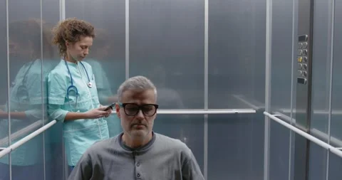 Man in wheelchair taking the elevator Stock Footage 308918025