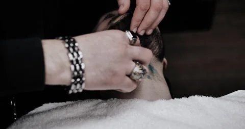 A man while barber applying shaving cream on his beard using shaving brush. Stock Footage 150271385