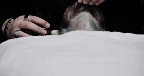 A man while barber applying shaving cream on his head using shaving brush. Stock Footage 150271472