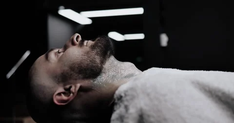 A man while barber applying shaving cream on his head using shaving brush. Stock Footage 150271597