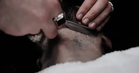 A man while barber applying shaving cream on his beard using shaving brush. 스톡 동영상 150271787