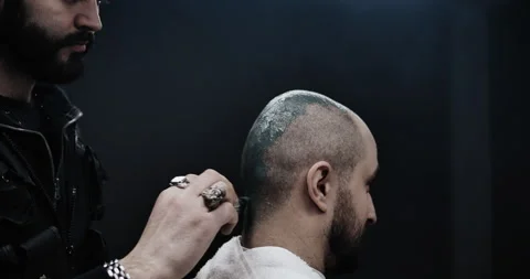 A man while barber applying shaving cream on his head using shaving brush. Stock Footage 150273398
