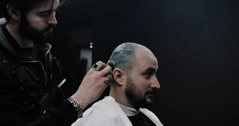 A man while barber applying shaving cream on his head using shaving brush. Stock Footage 150273434
