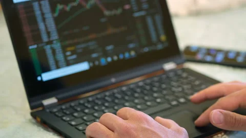 Man while doing crypto currency trading on a laptop,web business,smart working Stock Footage 156646892