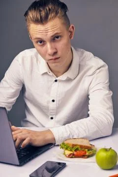 Man while lunch at the office looking at camera Stock Photos