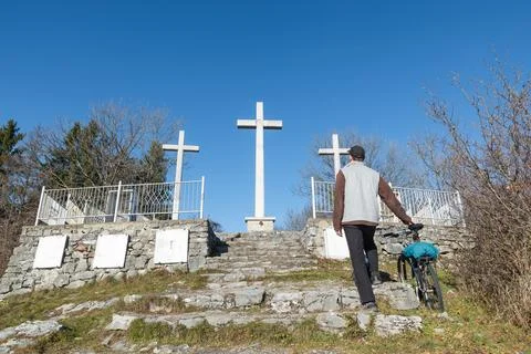 Man while praying to god in front of three cross at the end of a staircase Stock Photos