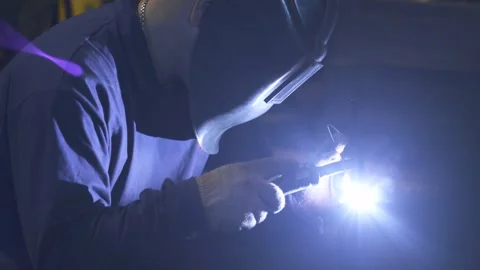 A man while working with a welding machine Stock Footage 288485011