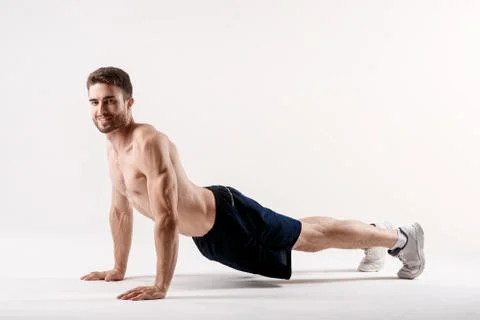 A man on a white background does an exercise on stretching his back. straight Stock Photos