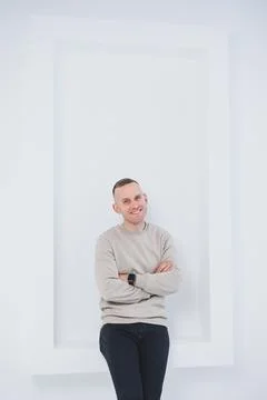 A man on a white background is dressed in raglan and black pants. Men's casua Stock Photos