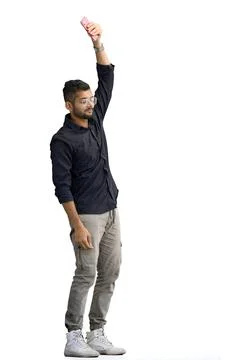 A man, on a white background, in full height, waving his phone Stock Photos