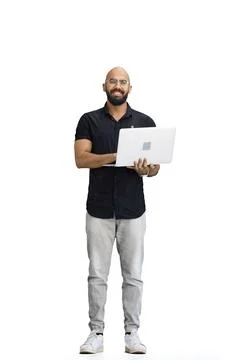 A man, on a white background, in full height, uses a laptop 스톡 사진