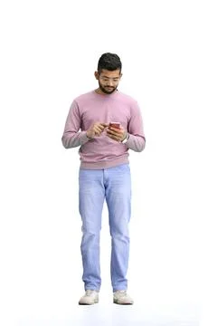 A man, on a white background, in full height, with a phone Stock Photos
