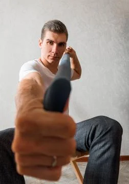 A man on a white background looks at the camera. men's photo shoot Stock Photos