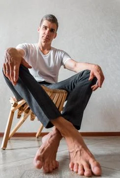 A man on a white background looks at the camera. men's photo shoot Stock Photos